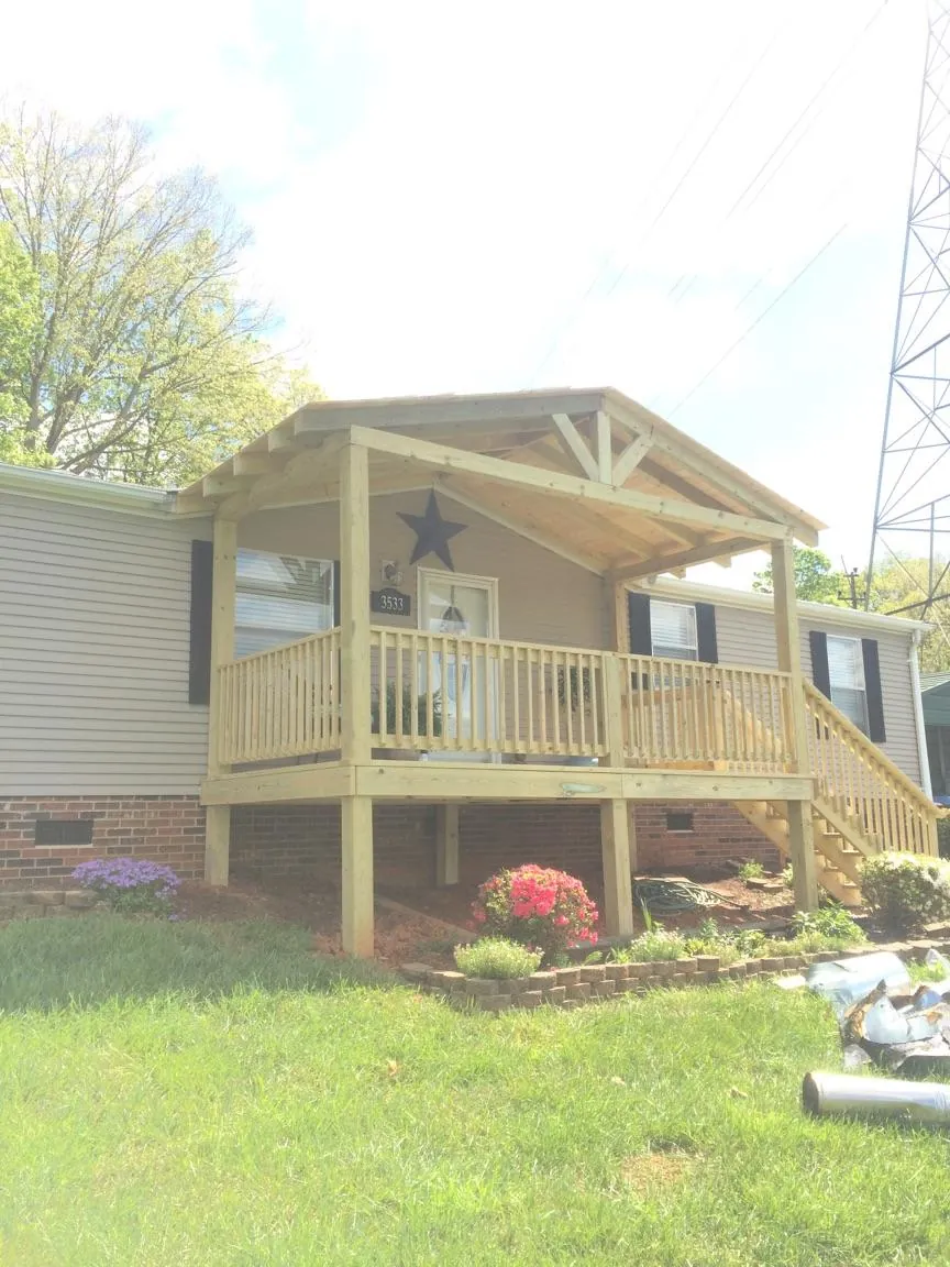 New gabled porch roof and deck railing added to a ranch home in Jamestown